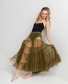 Such a beautiful tutu skirt . Full length and very very full with tiers of soft cascading tulle getting fuller so that the bottom of the skirt is fabulous and ruffly but the area around the waist is sheer so that you don't have a lot of fabric around your waist area  A stunning tutu skirt that can be worn with a chunky sweater or long cardigan or worn with a short jacket and leggings and sandshoes  Dress up or down the Celeste tutu skirt is a winner  2 very generous sizes .. the med / large easi Green Tulle Bottoms For Summer, Summer Green Tutu Dress With Ruffles, Fitted Tiered Tutu Dress For Summer, Summer Dance Tulle Petticoat, Summer Tiered Tulle Tutu Dress, Summer Dance Petticoat With Ruffles, Summer Balletcore Tutu Dress With Tulle Skirt, Summer Balletcore Tutu Dress, Summer Tiered Tutu Dress With Tulle Skirt