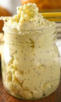 a jar filled with mashed potatoes on top of a wooden table