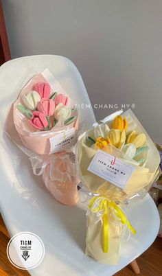 two bouquets of flowers are sitting on a white chair next to a package of macaroni and cheese