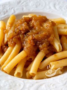 pasta with meat and sauce in a white bowl