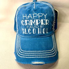 This Kbethos Trucker Hat Is A Colorful Addition To Any Outfit. The Blue And White Distressed Design Features The Playful Phrase "Happy Camper Fueled By Alcohol". With An Adjustable Strap, This One Size Fits All Cap Is Perfect For Men Who Want To Add Some Personality To Their Look. Whether You're Hitting The Road For A Camping Trip Or Just Want To Make A Statement, This Hat Is Perfect For You. Distressed Blue Hat With Adjustable Fit, Adjustable Distressed Blue Hat, Blue Letter Print Hat For The Beach, Blue Letter Print Hat For Beach, Distressed Blue Snapback Hat, Blue Beach Hat With Letter Print, Adjustable Blue Trucker Hat For Camping, Blue Adjustable Trucker Hat For Camping, Adjustable Blue Baseball Cap For Camping