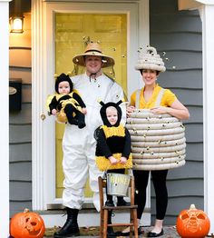 three people in costumes standing on the front porch