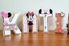 the letters are decorated with minnie mouses and balloons