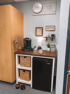 a kitchen with a black refrigerator freezer sitting next to a wooden cabinet and counter top