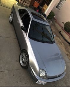 a silver car parked in front of a house