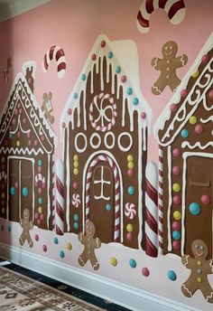 the wall is decorated with gingerbread houses and candy canes on it's sides