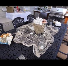 the table is set with plates and cups on it, along with other food items