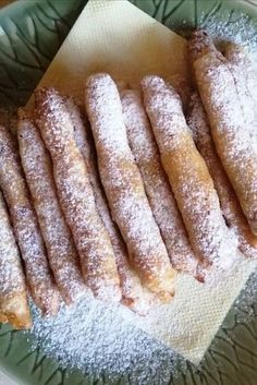 powdered sugar covered pastries on a green plate