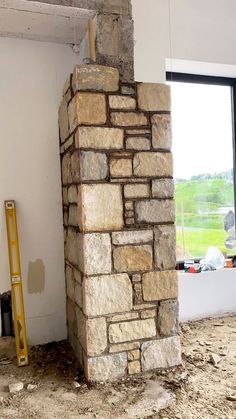 a brick fireplace in the middle of a room under construction