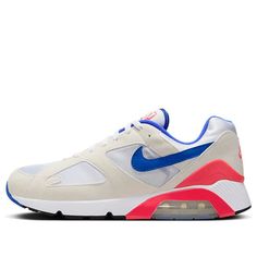 The Nike Air Max 180 'Ultramarine' 2024 is a retro running shoe that pays homage to the iconic OG colorway from the '90s. The upper features a white textile base with off-white suede overlays and a blue leather Swoosh. Bright red accents appear on the TPU heel counter, the 180 Air tongue tag, and the Nike Air branding embroidered on the back heel. The standout feature is the cushioning setup, which boasts 180 degrees of visible Air cushioning. Retro Sneakers With Air Cushioning For Streetwear, Nike Retro Sneakers With Air Max Cushioning, Retro Nike Sneakers With Air Max Cushioning, Retro Air Max Sneakers For Running, Retro Sneakers With Air Max Cushioning For Sports, Nike Retro Running Sneakers, Retro White Running Shoes With Boost Midsole, Retro Nike Running Sneakers, Retro Nike Sneakers For Running