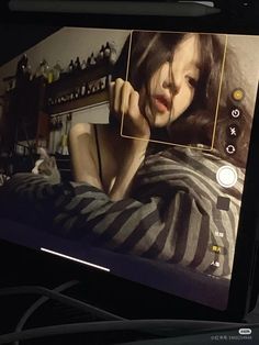 an image of a woman on the screen of a laptop