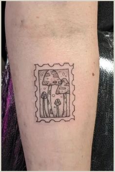 a tattoo on the leg of a person with an image of a mushroom in it