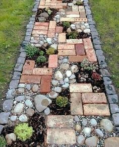 a garden path made out of bricks and stones