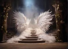 white angel wings on steps leading up to an altar