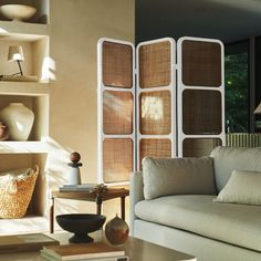 a living room filled with furniture and lots of windows