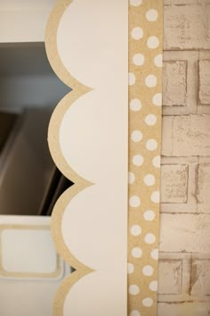 a close up of a brick wall with polka dots on it and a paper cutout in the middle