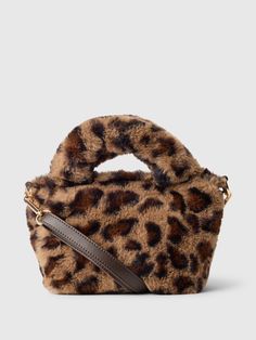 This bag is made with a faux fur upper.  Double handle and adjustable shoulder strap at top.  Snap button closure.  Fully lined.  Allover leopard print.  Dimensions: 6"H x 4" W x 6. 5" L Cheetah Print Bag, Leopard Print Handbags, Perfect Purse, Brand Collaboration, Gap Kids, Printed Bags, Hand Bags, Fall Wardrobe, Toddler Gifts