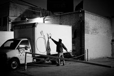 a man standing next to a white box truck