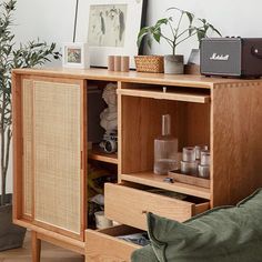 a living room with a couch and wooden cabinet