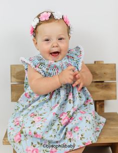 "**BLUE AND PINK FLORAL BABY DRESS (DRESS ONLY) --> MANY PRINTS AND COLORS AVAILABLE---> https://www.etsy.com/shop/BySophiaBaby?ref=seller-platform-mcnav&search_query=1130 { DRESS DESCRIPTION }: - Unique Baby Dress, made with 100% COTTON, with a beautiful handicraft detail called \"Bee House\" or \" Hive\" on upper part of the dress. - This listing is for the Dress only, if you want to purchase a matching headband please click on the links below: ---> Flower Crowns: https://www.etsy Fitted Blue Dress For First Birthday, Blue Fitted Dress For First Birthday, Blue Sleeveless Dress For First Birthday, Blue Dress For First Birthday In Summer, Playful Baptism Dress With Ruffles, Playful Pink Dress For Baptism, Playful Pink Baptism Dress, Ruffled Baby Bloomers, Baby Ruffle Romper