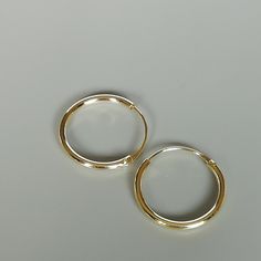 16mm sterling silver endless ear hoops, dipped in gold. Size: 1.5 x 16 mm These earrings are made of real 925 hypoallergenic sterling silver, dipped in real gold. Will be packaged in a gift box. Please let me know if you don't want it in one. I can write out a message from you to the receiver if needed. Please be free to contact me at... bhavnakwintra1956@gmail.com More hoops: https://www.etsy.com/your/shops/TheSilverGame/tools/listings/section:26305414 More earrings: https://www.etsy.com/your/s Simple Small Adjustable Hoop Earrings, Gold Sterling Silver Hoop Nose Rings, Simple Adjustable Small Hoop Jewelry, Adjustable Simple Small Hoop Jewelry, Simple Nickel-free Hoop Cartilage Earrings, Minimalist Small Hoop Earrings Cadmium-free, Gold Hypoallergenic Hoop Cartilage Earrings, Adjustable Small Hoop Cartilage Earrings, Adjustable Hoop Nose Rings For Everyday