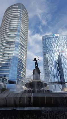 a fountain in front of two tall buildings