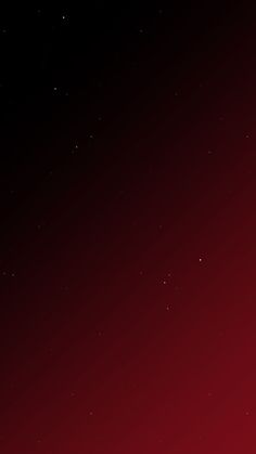 a red and black background with stars in the sky