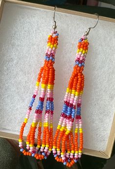 Orange petite stitch beaded earrings. Earrings measure 3 inches.  *made by a local artist* Unique Orange Beaded Earrings, Unique Orange Beaded Earrings With Colorful Beads, Unique Multicolor Beaded Earrings, Multicolor Beaded Chain Earrings As Gift, Multicolor Beaded Chain Earrings For Gift, Orange Beaded Earrings With Tiny Round Beads, Adjustable Orange Tiny Beads Earrings, Beaded Jewelry Diy, Jewelry Diy