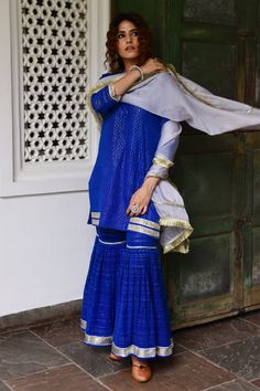 Deep blue straight short kurta with hand embroidered gota trims. Paired with striped pattern sharara and powder blue organza dupatta with fringe border.
Component: 3
Embroidered
Neckline: Round
Sleeve Length: Three Quarter
Fabric: Kurta: Cotton Lurex; Dupatta: Organza; Lining: Cotton
Color: Blue
Split neck
Striped pattern
Side slits
Fringe dupatta - Aza Fashions Fringe Dupatta, Yellow Kurta, Kurta Cotton, Blue Organza, Blue Kurta, Short Kurta, Pink City, Suits Design, Sharara Set