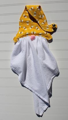 a yellow and white towel hanging from a hook on the side of a garage door