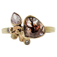 a gold ring with two brown diamonds on it