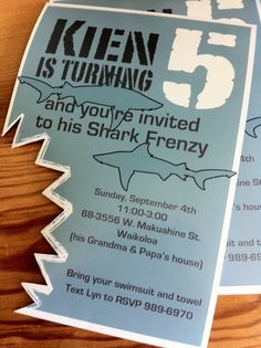 two shark themed birthday party flyers on a wooden table with the number five in it