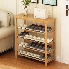 there is a shoe rack with many pairs of shoes on it next to a couch