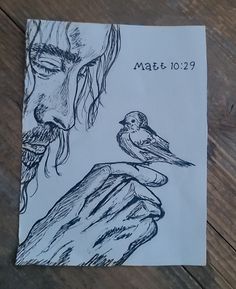 a piece of paper with a drawing of a man holding a bird on it's hand