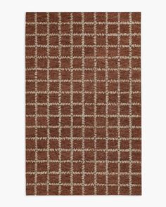 a brown and white rug with squares on it