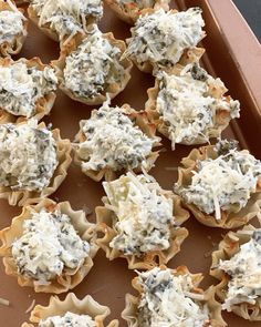 a tray filled with cupcakes covered in blue cheese