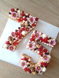 the number five cake is decorated with flowers and chocolates on it's side