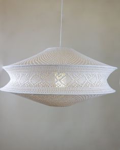 a large white light hanging from a ceiling