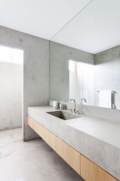 a bathroom with two sinks and mirrors in it