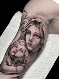 a woman and child tattoo on the arm