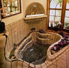 a bathtub in the middle of a tiled room