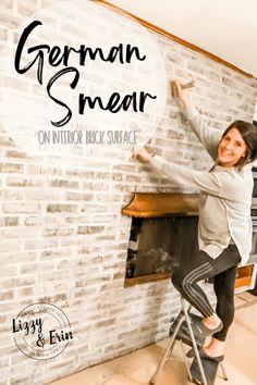 a woman standing on a stool in front of a brick wall with the words german swear on it