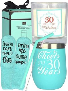 a candle and some socks are in front of a box with the words 30 years on it