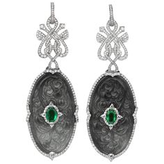 A pair of drop earrings set with carved and pierced oval grey jade plaque, centered with an oval-cut emerald, both in a brilliant-cut diamond surround with rose-cut diamond highlights, suspended from a brilliant-cut diamond-set openwork plaque and detachable hoop, mounted in 18-carat white gold, push on butterfly fittings. Could be able to wear it as a pendant. Divine pair of earrings, dark grey jade crystal, white gold, emerald, and white diamonds. Delicate to the touch, but with a royal sophis Jade Design, Antique Jade, Chinese Jewelry, Jade Crystal, Diamond Jewelry Designs, Jade Earrings, Crystal White, Earrings Pendant, Art Nouveau Jewelry