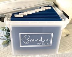 a plastic storage box filled with files on top of a table