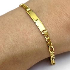 This beautiful bracelet is made of high-quality 10K yellow gold and features a 3.5mm Figaro chain that adds a touch of elegance to any outfit. The ID bar can be personalized with your choice of engraving, making it a perfect gift for a loved one or a special treat for yourself. The bracelet measures 6 inches in length and features a secure and easy-to-use lobster clasp. Wear it alone or pair it with other bracelets for a trendy layered look. Product Specifics All specifications are approximate and may vary for the same model. Weight 3g Metal Yellow Gold Metal Purity 10K Finish High Polished Link Style Figaro Link Type Hollow Clasp Type Lobster Claw Length 6" Width 3.5mm Crafted in Europe Style ID: 11170 ZF-L (internal use only): WJDALI 30-Day Free Returns Enjoy a 30-day return period with Classic Yellow Gold Rectangular Name Bracelet, Rectangular Yellow Gold Name Bracelet, Classic Yellow Gold Nameplate Chain Bracelet, Classic Rectangular Name Bracelet, Tarnish Resistant, Classic Yellow Gold Nameplate Bracelet, Classic Nameplate Bracelet Tarnish Resistant, Rectangular Yellow Gold Bracelet With Polished Finish, Classic Tarnish Resistant Nameplate Bracelets, Classic Tarnish Resistant Name Bracelet