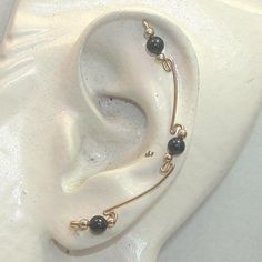 "An ear sweep is sort of a bobby-pin style earring made to fit the outside ridge of your ear, starting in the earlobe piercing and sweeping UP the side of your ear! A multiple-pierced look without the extra pain--too cool! This is a simple design but extra-long, sweeping all the way up your ear! With three shiny 4mm black onyx beads, and small 14kt gold filled accent beads. Approximately 2-3/8\" long and crafted with 14kt gold filled wire. Sold in pairs. I can make these ear sweeps in either sil Handmade Black Ear Cuff, Handmade Adjustable Black Ear Cuff, Handmade Black Ear Cuff For Gift, Handmade Black Ear Cuff As Gift, Handmade Black Ear Cuff Gift, Ear Sweeps, Garnet Bead Bracelet, Ear Climbers, Bobby Pin