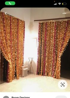 the room is decorated with gold and red beaded curtains, black doors, and a toilet