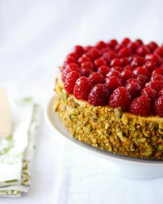 a close up of a cake on a plate with raspberries in the middle