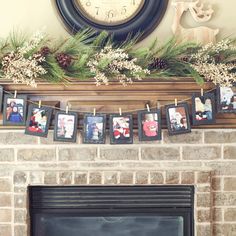 a mantle decorated for christmas with pictures and pine cones